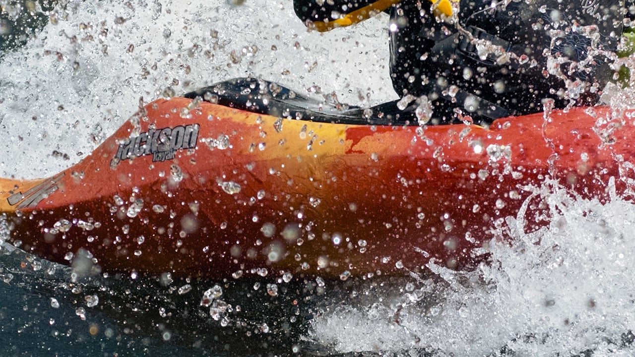 Whitewater kayaking action shot demonstrating slow-motion capture on the GoPro Mission 1 Pro ILS