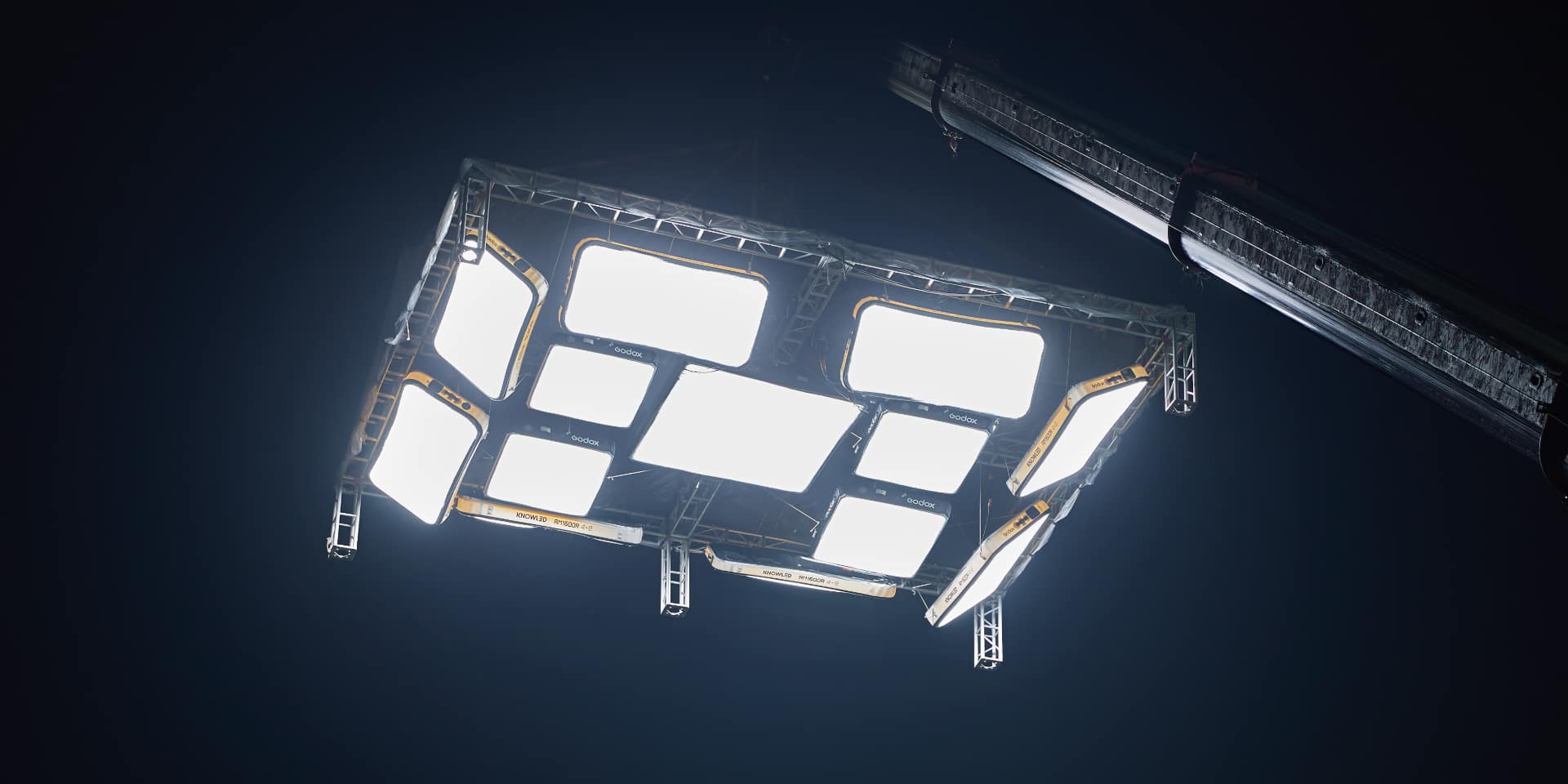 Multiple Godox KNOWLED AM800R and AM1600R panels linked via D-rings into a large overhead lighting rig