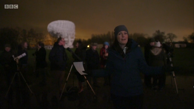 Prof. Lucie Green presenting to camera in the dark BBC