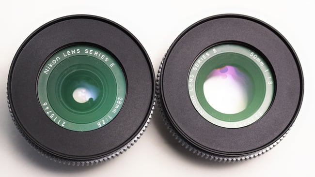 Maximum entrance pupil. The 28mm lens (left) has a maximum aperture of f 2.8, while the 50mm achieves 1.8. Notice the larger hole in the 50