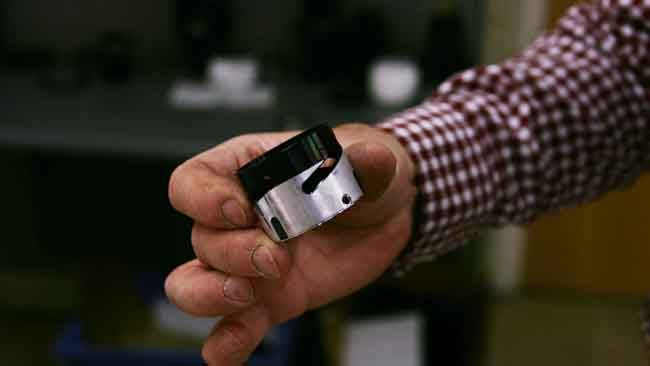 The irregular slot in this tube is an example of the sort of strange mechanisms that are involved in precision lens parts