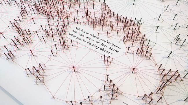 This web of coloured cotton strands represents the way in which fragments of information can be joined up. Spot the hidden message.jpg