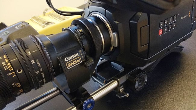 Blackmagic Ursa Mini 4.6K with Canon HJ11x4.6B lens. In the background, a tray of newly-manufactured EF mounts. RedShark News