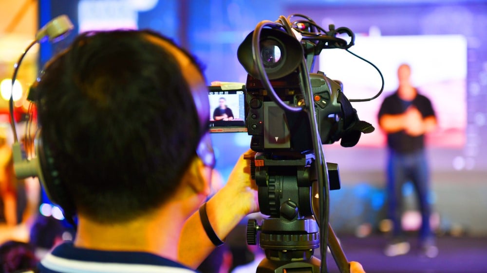 Small camera shooting live presenter for streaming production Shutterstock