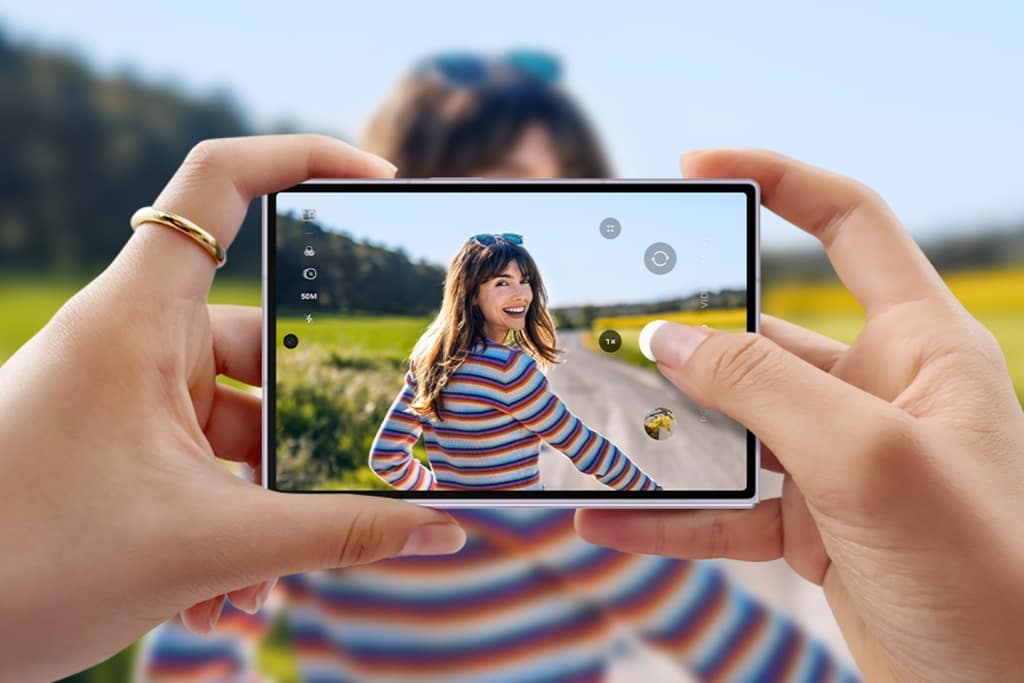Galaxy Z Fold 8 held in landscape, camera app open in 50 MP wide mode, photographing a woman outdoors