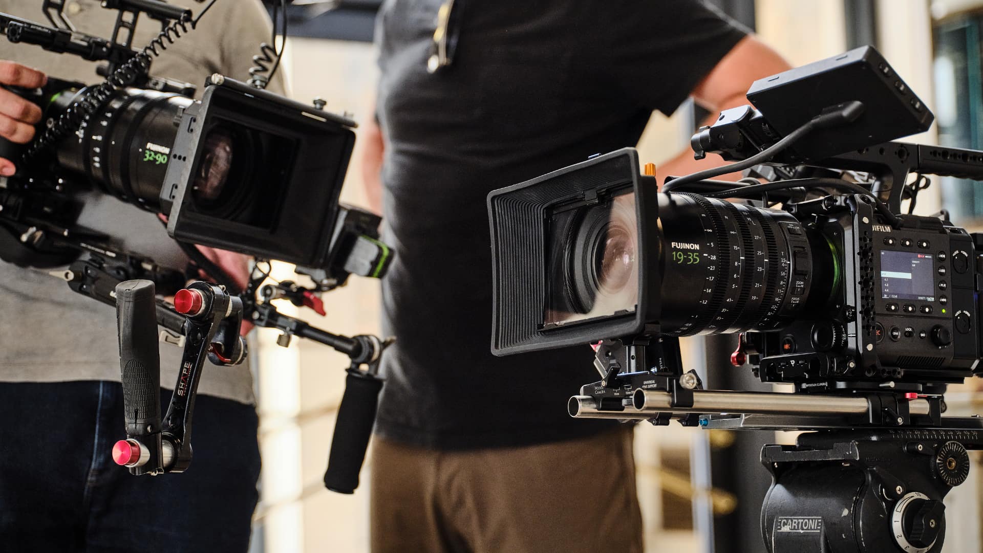 FUJINON GF19-35mm T3.5 and GF32-90mm T3.5 cinema lenses side by side on rigs during a shoot
