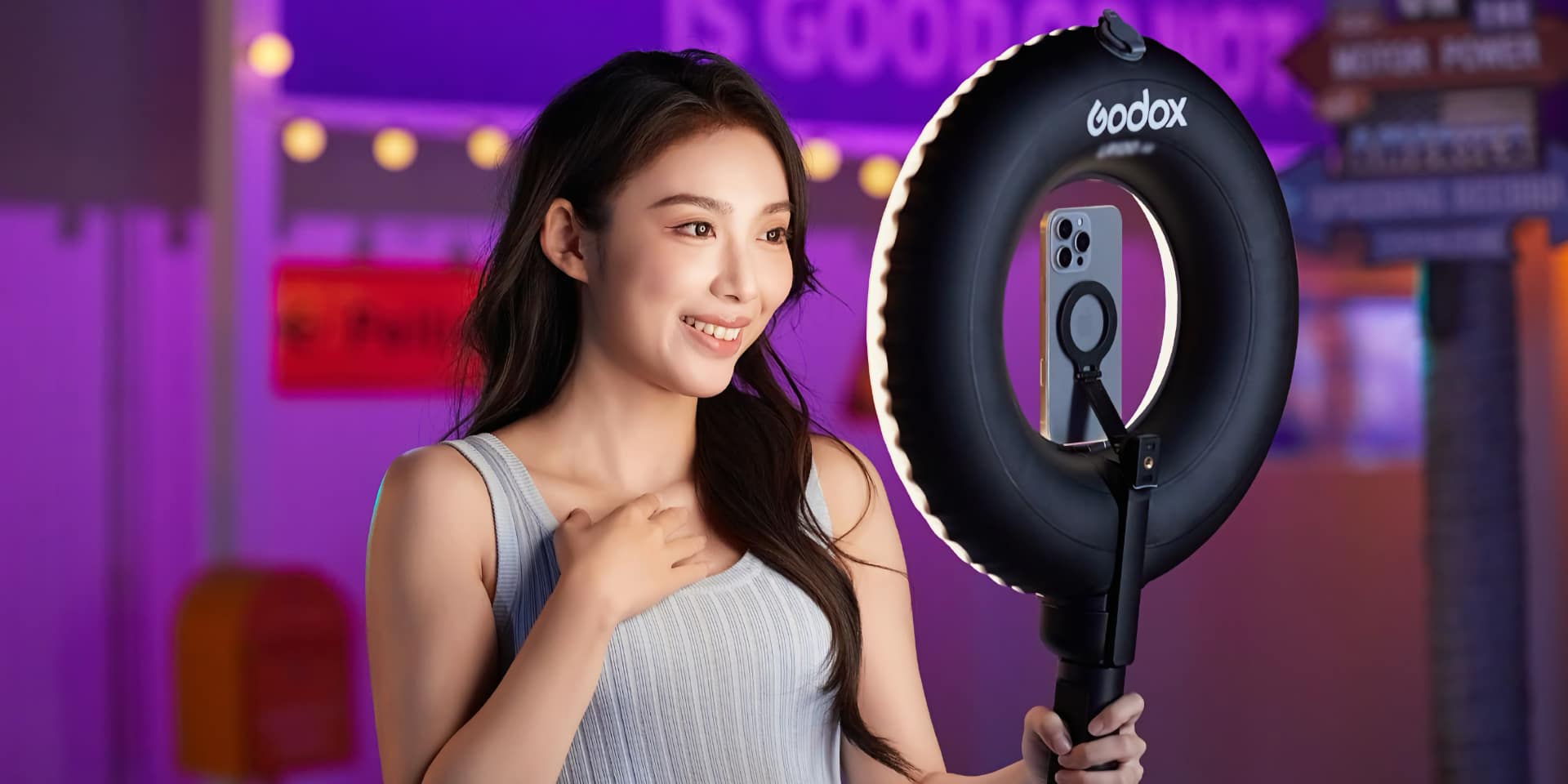Godox LR150 Air ring light in use with a smartphone mounted in the centre via MagSafe holder in a studio setting