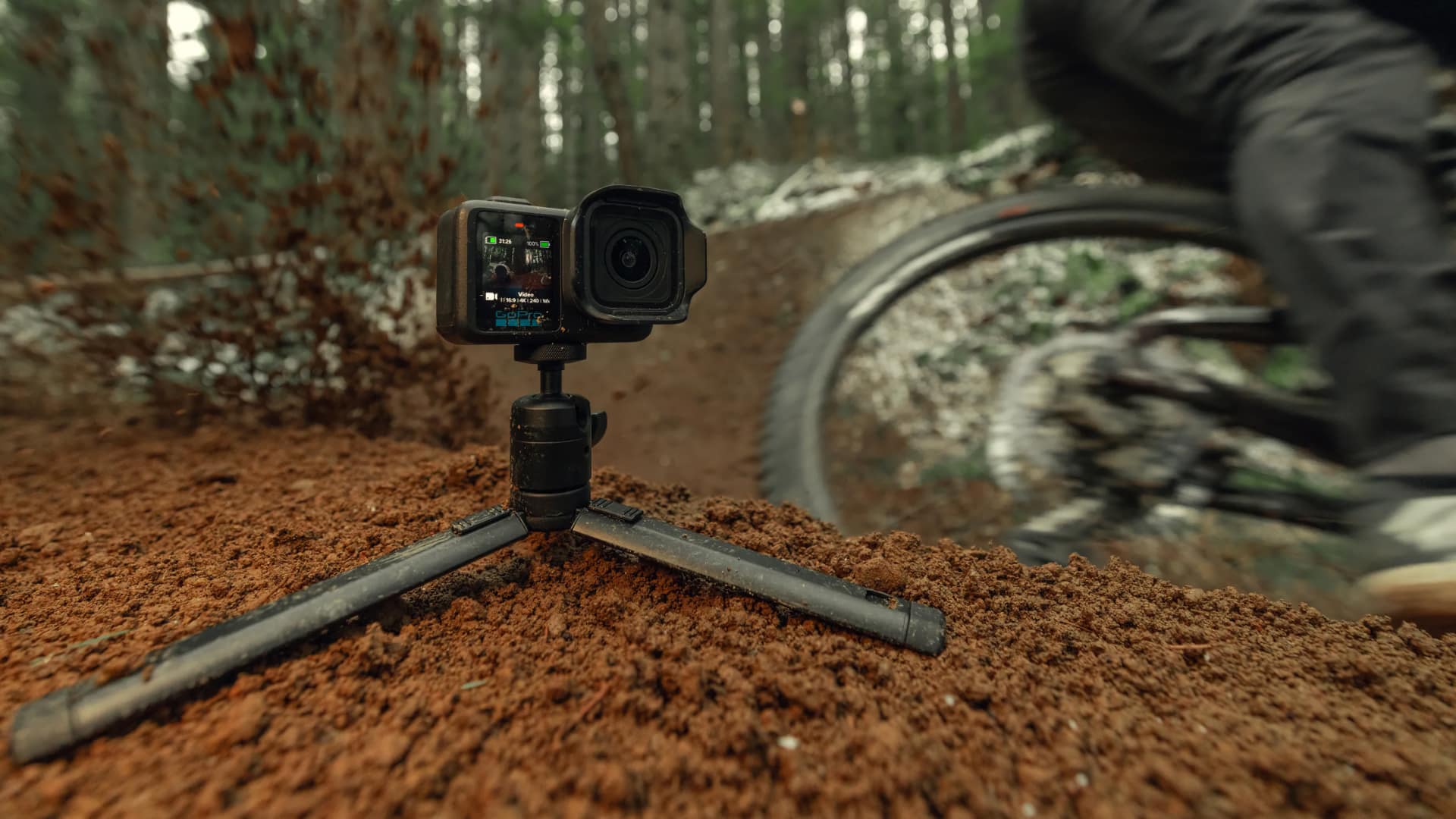 GoPro Mission 1 Series camera mounted on tripod at mountain bike trail location