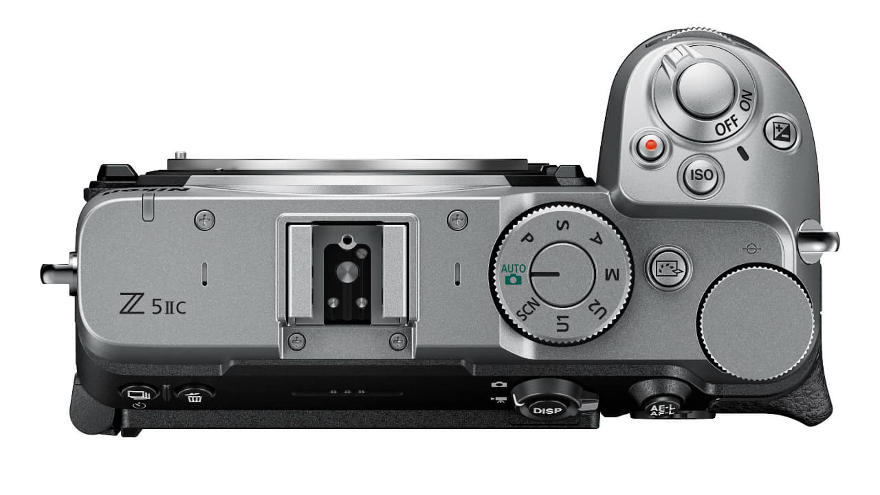 Nikon Z5IIC in silver seen from above showing mode dial and hot shoe on a flat top with no viewfinder