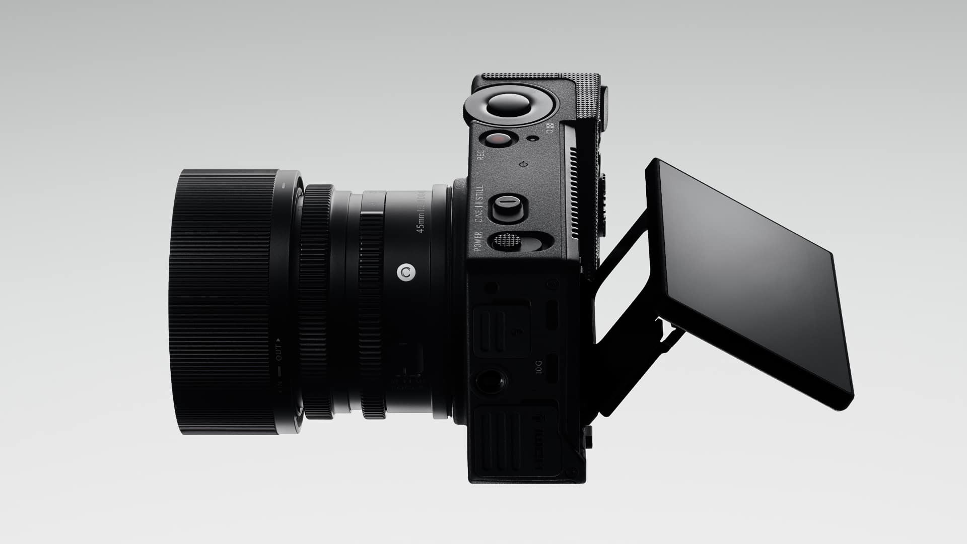 Sigma FP2 side view with the rear LCD angled out from the body and CINE STILL and power switches on the top plate
