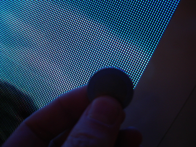 Sony's CLEDIS display. That's a British penny in direct contact with the display - small, but not cellphone-worthy. Things are improving, though.