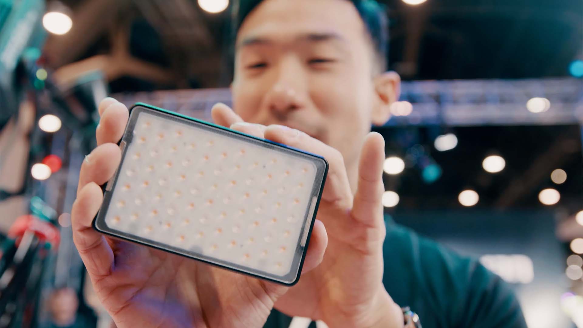 Ted Sim, co-founder and president of Aputure,  holds up an MC 12 mini LED.